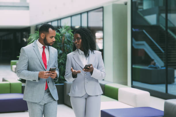 istock Diverse business professionals using mobile phones 1213465847