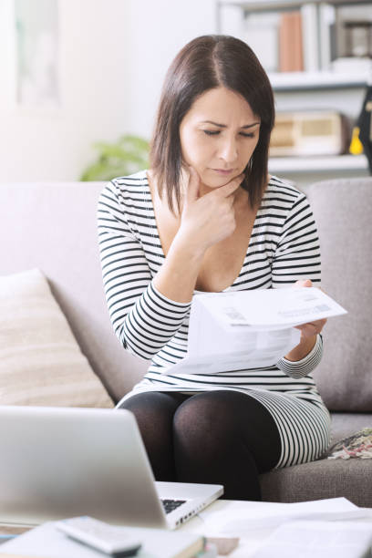 istock Woman checking her electricity bill 1213466937