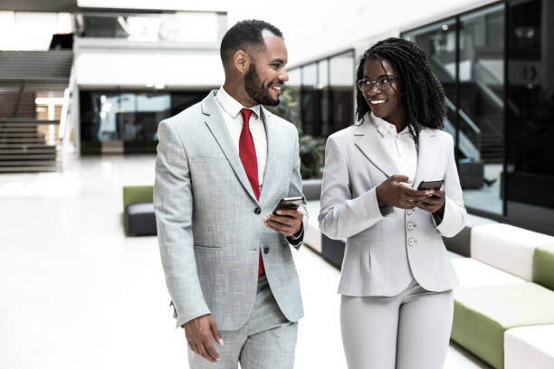 istock Happy business colleagues using mobile phones and chatting 1213466986