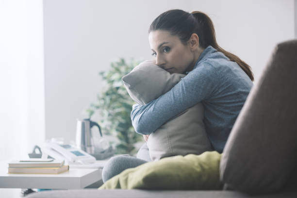 istock Sad woman hugging a pillow 1213468365