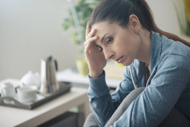 istock Depressed woman at home 1213468633