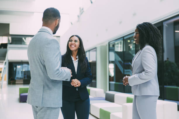 istock Three diverse business partners meeting in office hall 1213468900