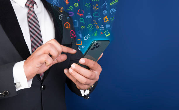 istock Professional man using smart mobile phone with app icons floating around 1213470085