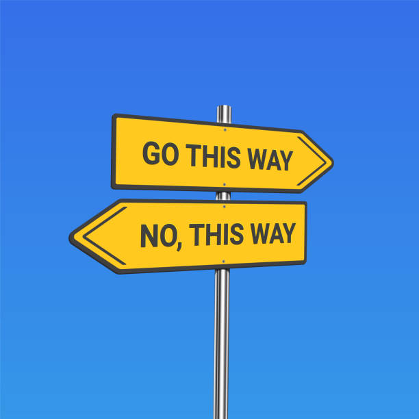 istock Yellow road signs with 'go this way / no, this way' text on a pole, vector illustration 1213470179