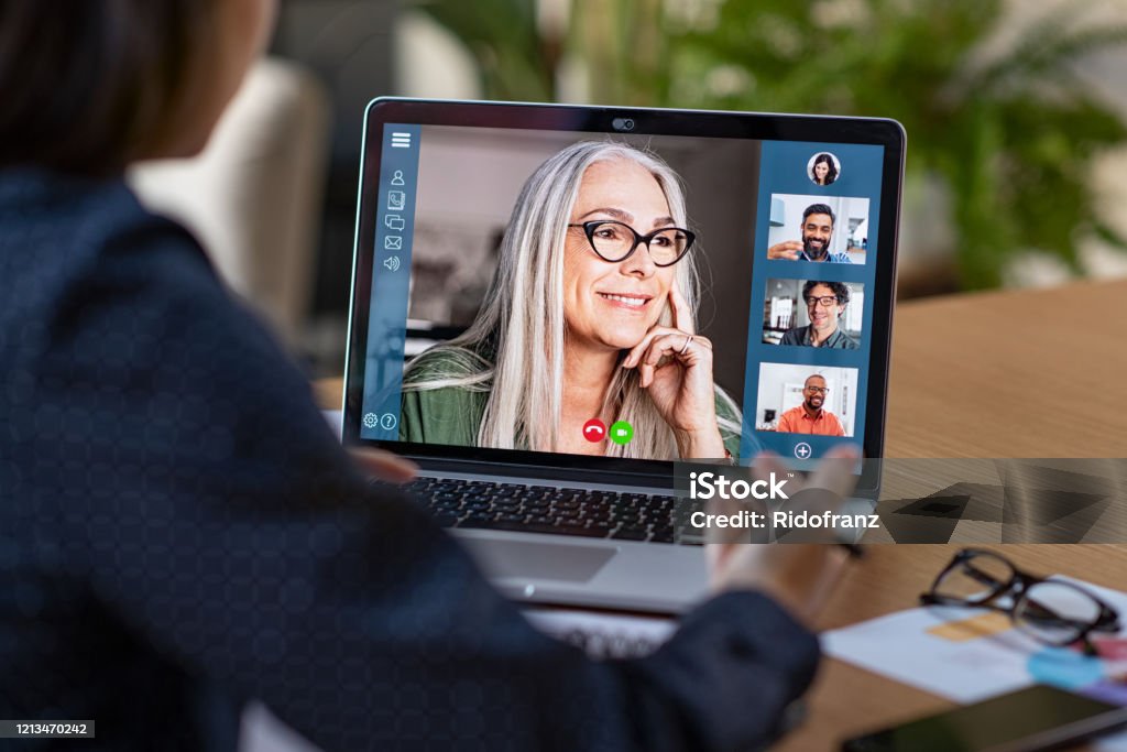 Business team in video conference Multiethnic business team having discussion in video call. Rear view of business woman in video conference with boss and his colleagues during online meeting. Senior woman making video call with partners using laptop at home: remote job interview, consultation, human resources concept. Video Conference Stock Photo Business team in video conference Multiethnic business team having discussion in video call. Rear view of business woman in video conference with boss and his colleagues during online meeting. Senior woman making video call with partners using laptop at home: remote job interview, consultation, human resources concept. Video Conference Stock Photo