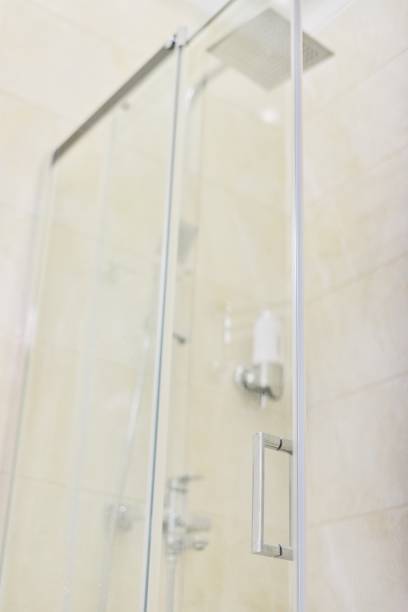 istock Shower, bathroom interior, light beige, glass door with chrome handle 1213470853