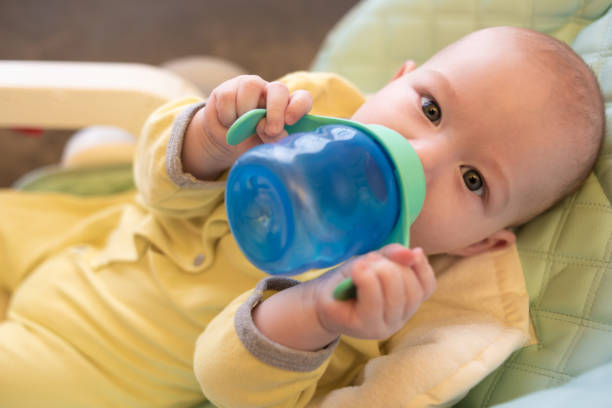 istock The baby drinks water from a bottle. 1213477716