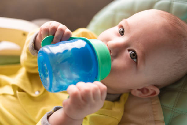 istock The baby drinks water from a bottle. 1213477766