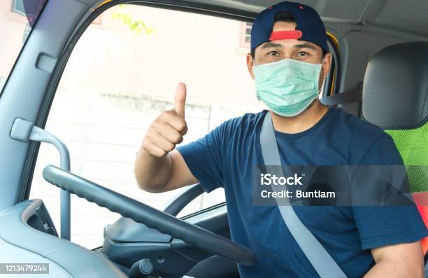 Truck Driver Wearing A Mask Stock Photo - Download Image Now - Essential Services, Protective Face Mask, Truck Driver