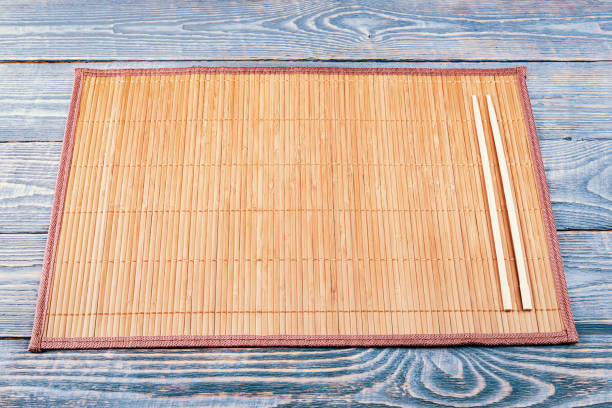 istock Two wooden chopsticks on a bamboo mat 1213479478