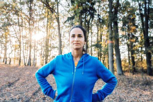 istock sportswoman standing in the nature 1213480606