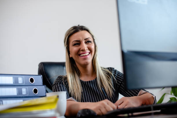 istock Businesswomen looking at computer and smiling 1213486276