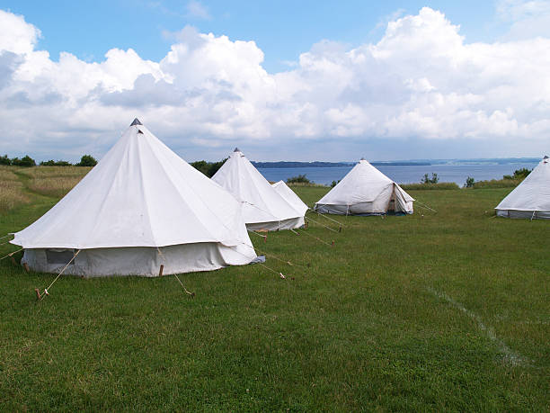 Classical tents by the beach ocean stock photo