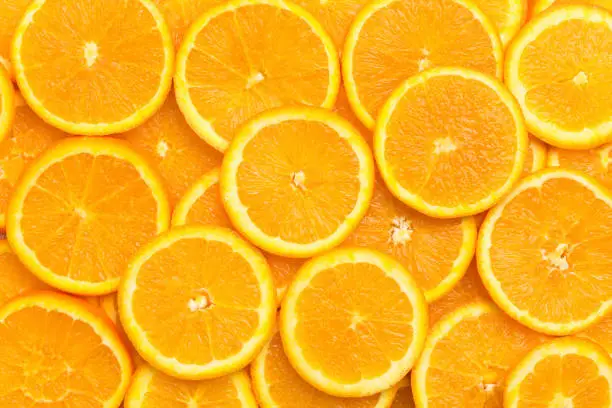 Fresh orange fruit slices pattern background, close up