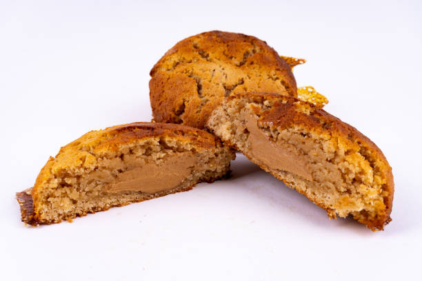 istock A cut cookie cake with peanut butter and caramel on white background with copy space - angled view 1213490475