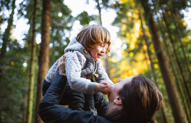 istock Toddler playing in the forest with his mother 1213492568