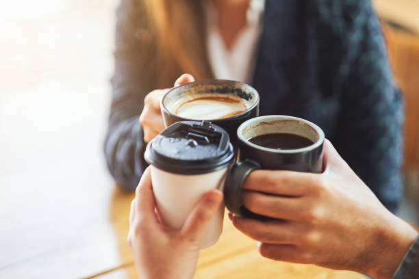 istock people enjoyed drinking and clinking coffee cups on the table in cafe 1213492650