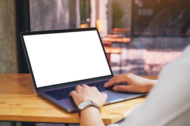 istock a woman using and typing on laptop computer with blank white desktop screen on wooden table 1213492667