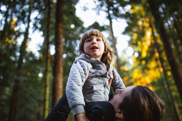 istock Toddler playing in the forest with his mother 1213492889