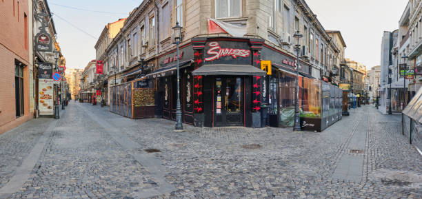 Bucharest, Romania - March 19, 2020: Sinners pub in empty Bucharest old city center, closed down in order to mitigate the spread of the Coronavirus (COVID-19) outbreak.