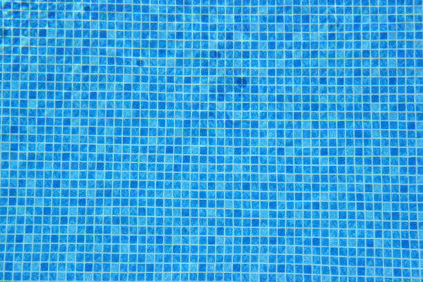 istock Top view of clear water in a blue tile pool background. Ripple effect 1213496556