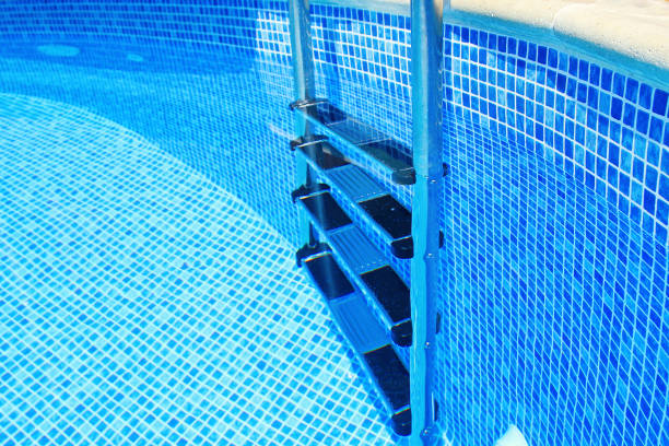 istock Stairs to the pool filled with clean water. Chrome plated surface. 1213498317