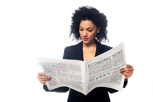 Front view of beautiful african american businesswoman reading newspaper isolated on white