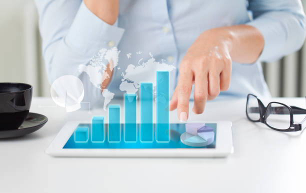 istock Businesswoman using tablet pc analyzing sales data and economic growth graph chart 1213499299