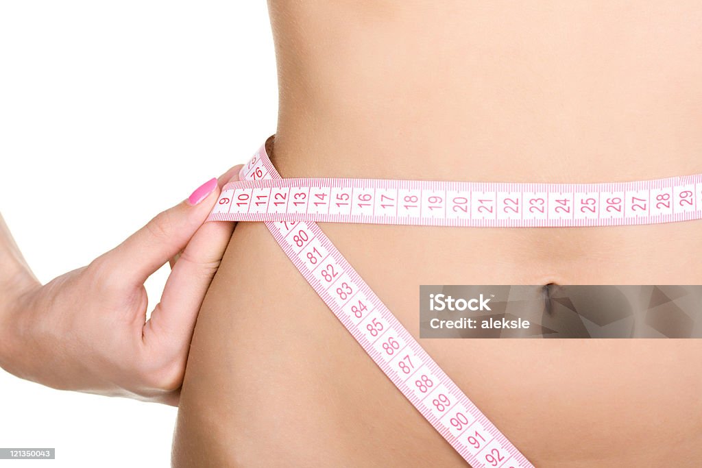 Demonstration of a weight loss program featuring slim waist Girl and tape measure around waist Abdomen Stock Photo