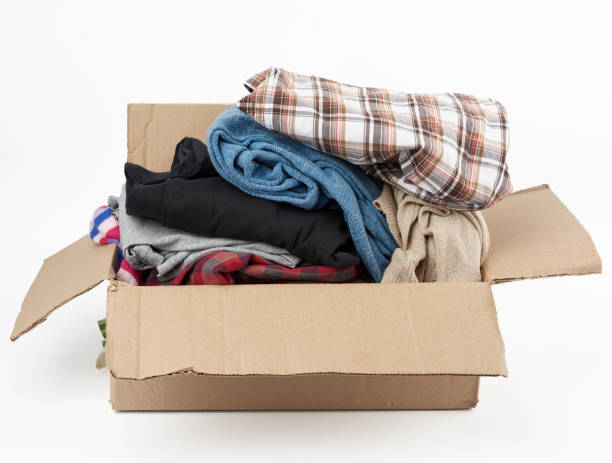 istock big brown cardboard box filled with various clothes on a white background 1213503035