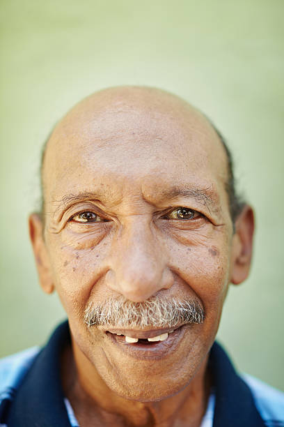 istock aged latino man smiling at camera 121350317