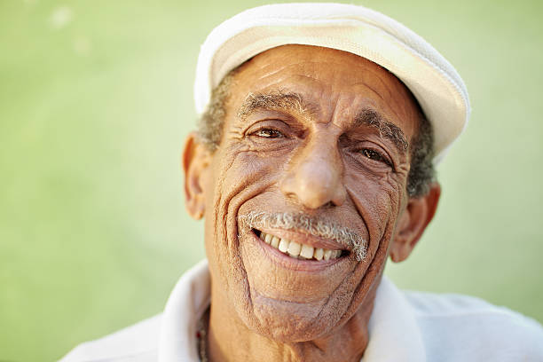 istock aged latino man smiling at camera 121350338