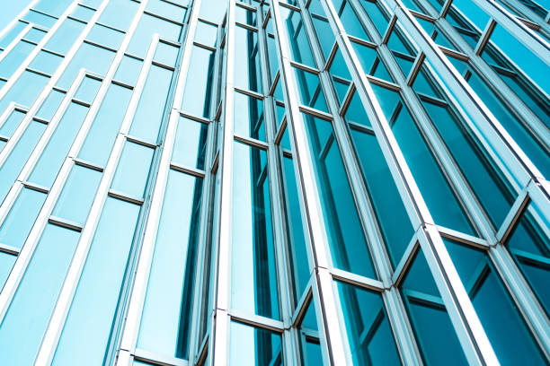 istock underside panoramic and perspective view to steel Tiffany blue glass high rise building skyscrapers, business concept of successful industrial architecture 1213504840