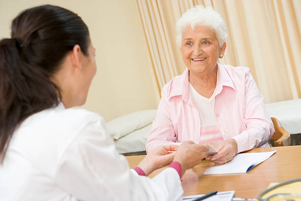 istock Woman in doctor's office smiling 121350526