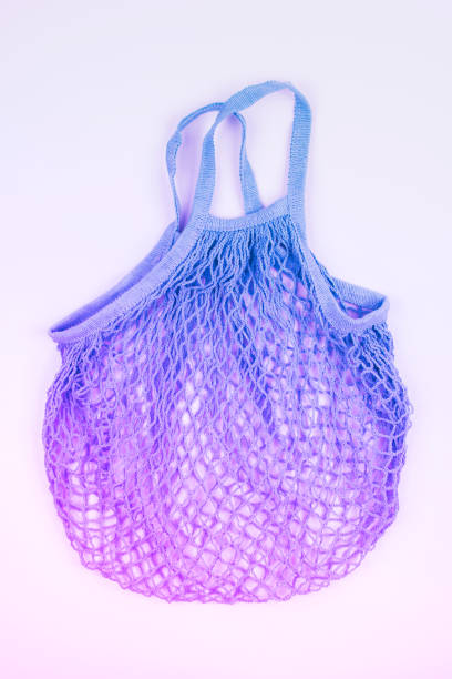 istock Empty reusable string eco bag for shopping in neon pink and blue colors. Zero waste and plastic free concept.  View from above. 1213505322