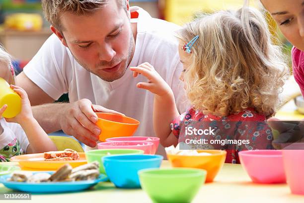 Man Playing With Children Using Colorful Cups Stock Photo - Download Image Now - Preschool Building, Preschool, Men