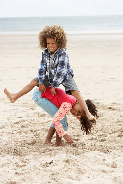 istock Happy children playing on beach 121350569
