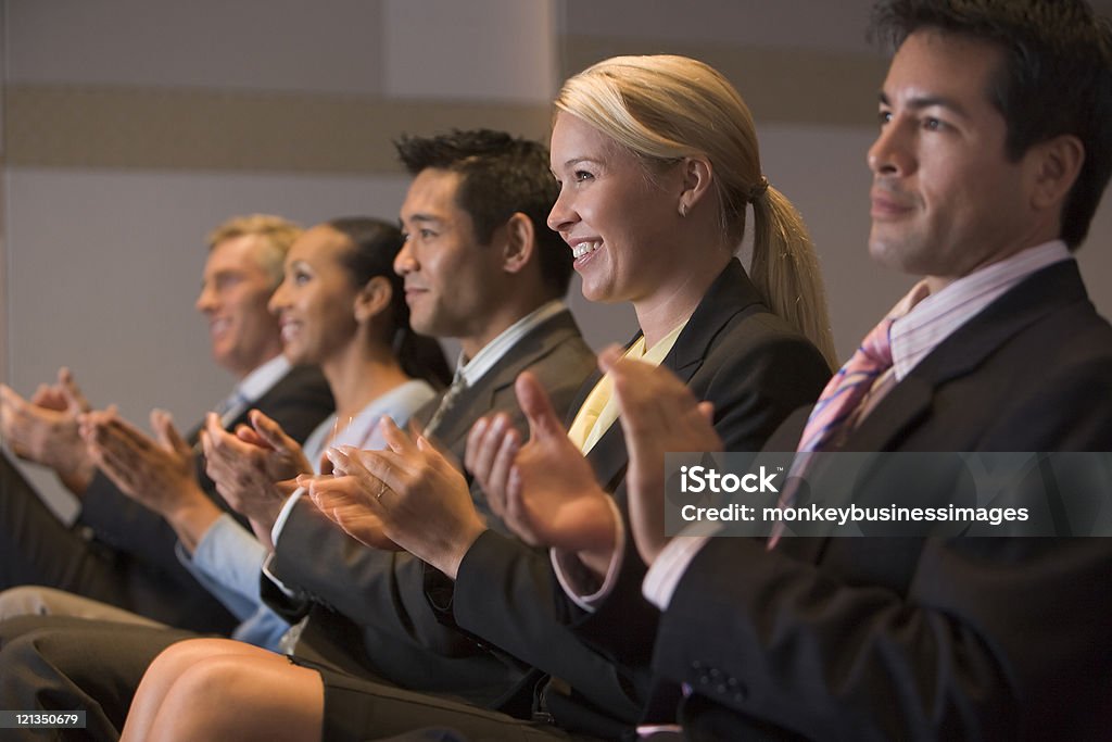 Businesspeople applauding in presentation room  Applauding Stock Photo