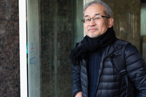 istock Senior man coming out of building 1213507190