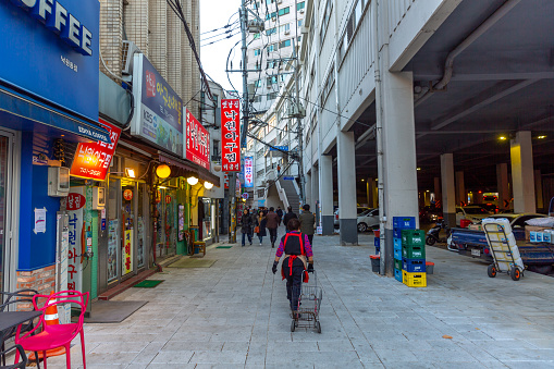 This pic shows  Myeong-Dong Neon ares with neon Lights in Seoul, South Korea. The location is the premiere district for shopping in the city. Local people walking in the area for shopping can be seen in the pic with sign board of shops.\nThe pic is taken in november 2019.