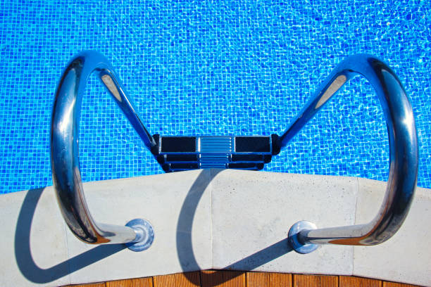 istock Stairs to the pool filled with clean water. Chrome plated surface. 1213508473