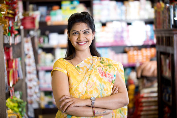 Woman in grocery aisle of supermarket Happy woman owner with arms crossed at grocery aisle of supermarket culture of india photos stock pictures, royalty-free photos & images