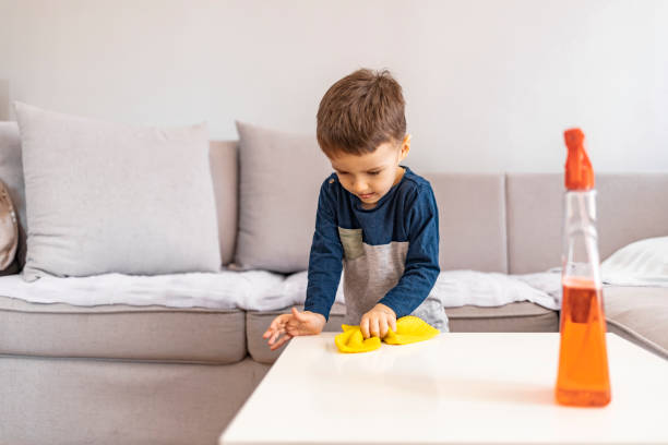 istock Cute boy wipes the dust on table 1213511410