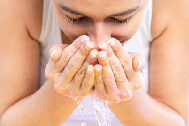 istock Young woman washing her face 1213513217