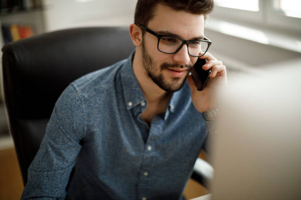 istock Smiling businessman talking on the phone 1213513539