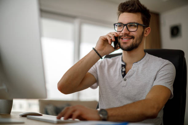 istock Young man talking on the phone at home 1213513634