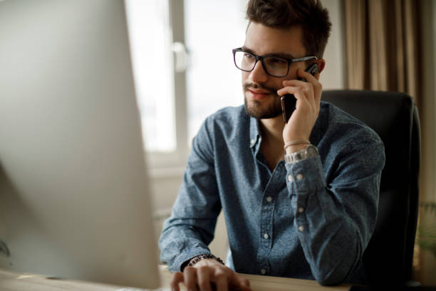 istock Young businessman using mobile phone in office 1213513788
