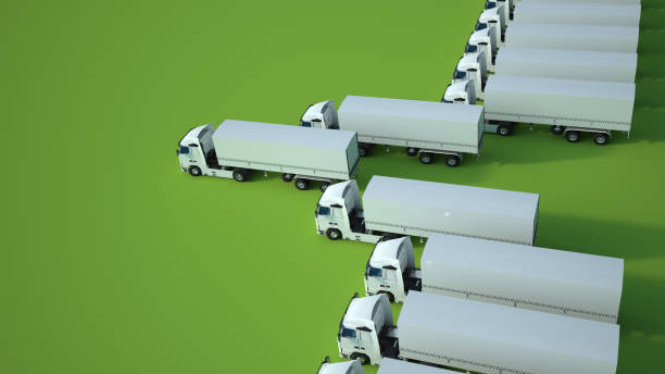 istock white trucks, green background aereal view 1213514687