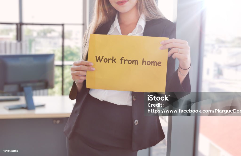 Business women holding sheet of paper with text work from home for protect virus and take care of their health from COVID-19. Working at home concept with flare effect. Change Stock Photo