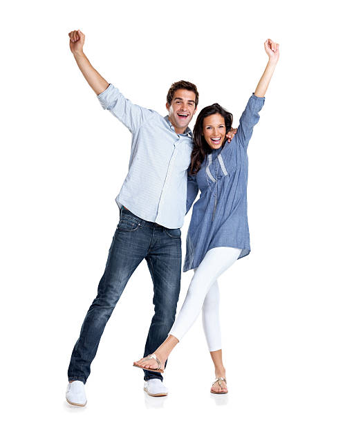 istock Young couple celebrating success with hands raised 121351489